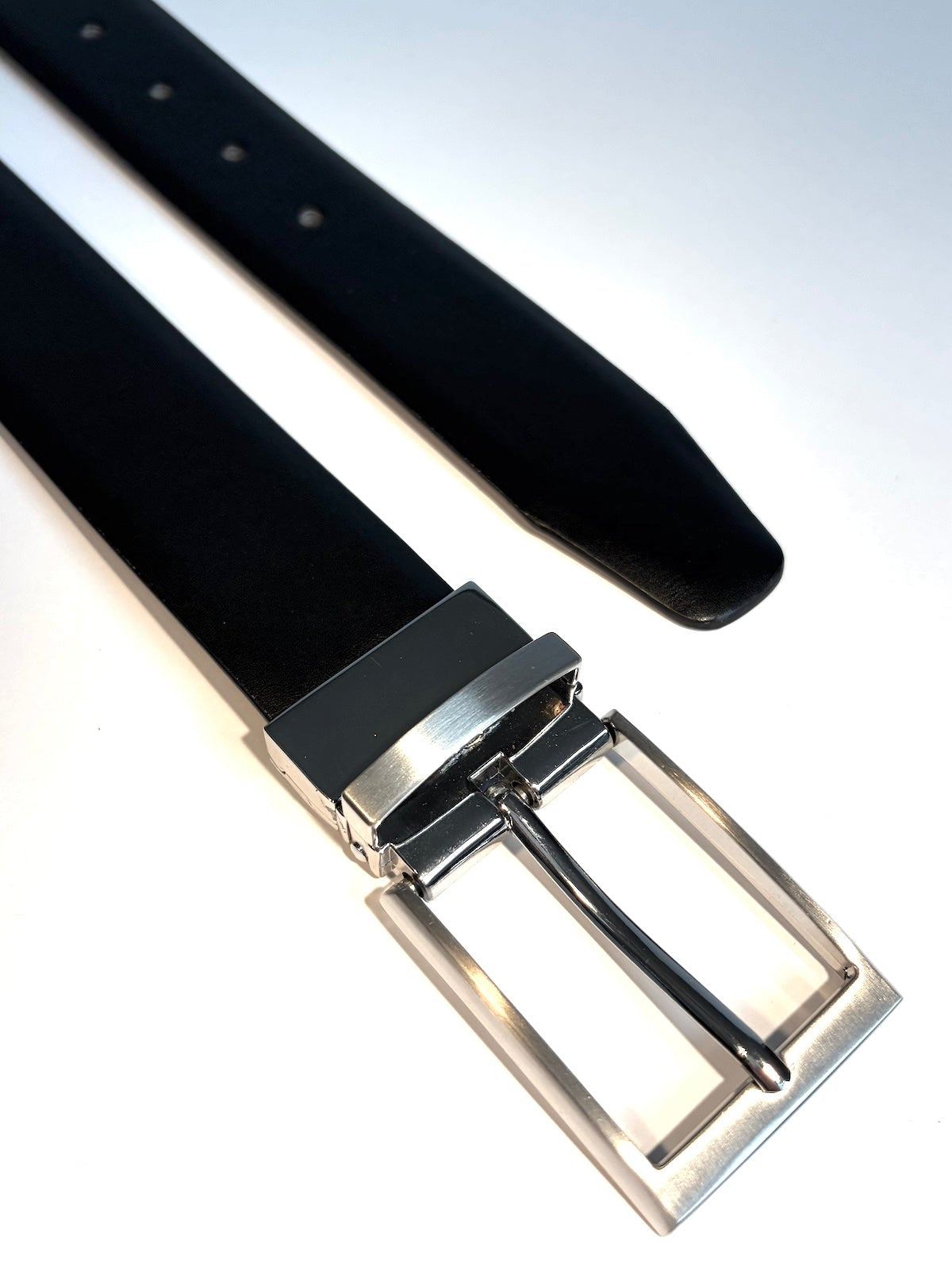 Black belt with a silver buckle on a white background