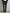 Man wearing a navy smart pants against a plain background