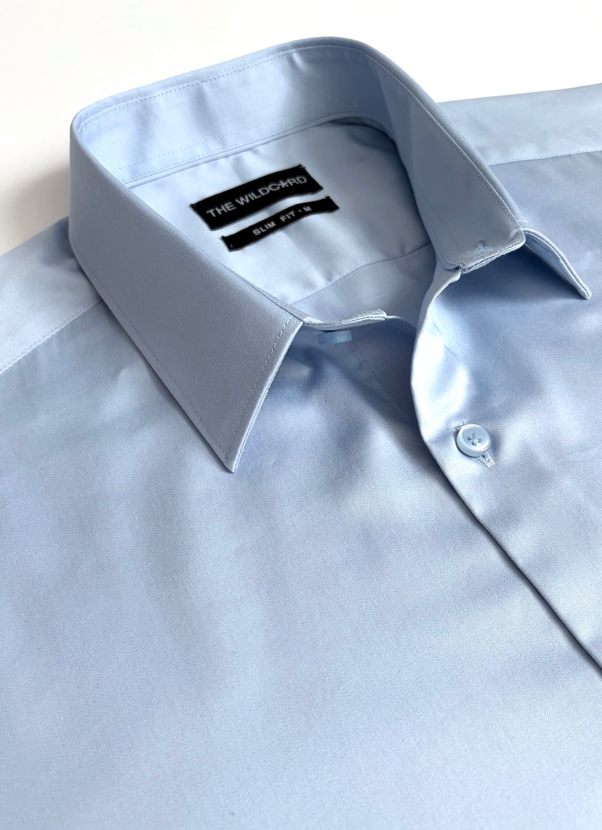 Light blue smart shirt with collar and label on a white background