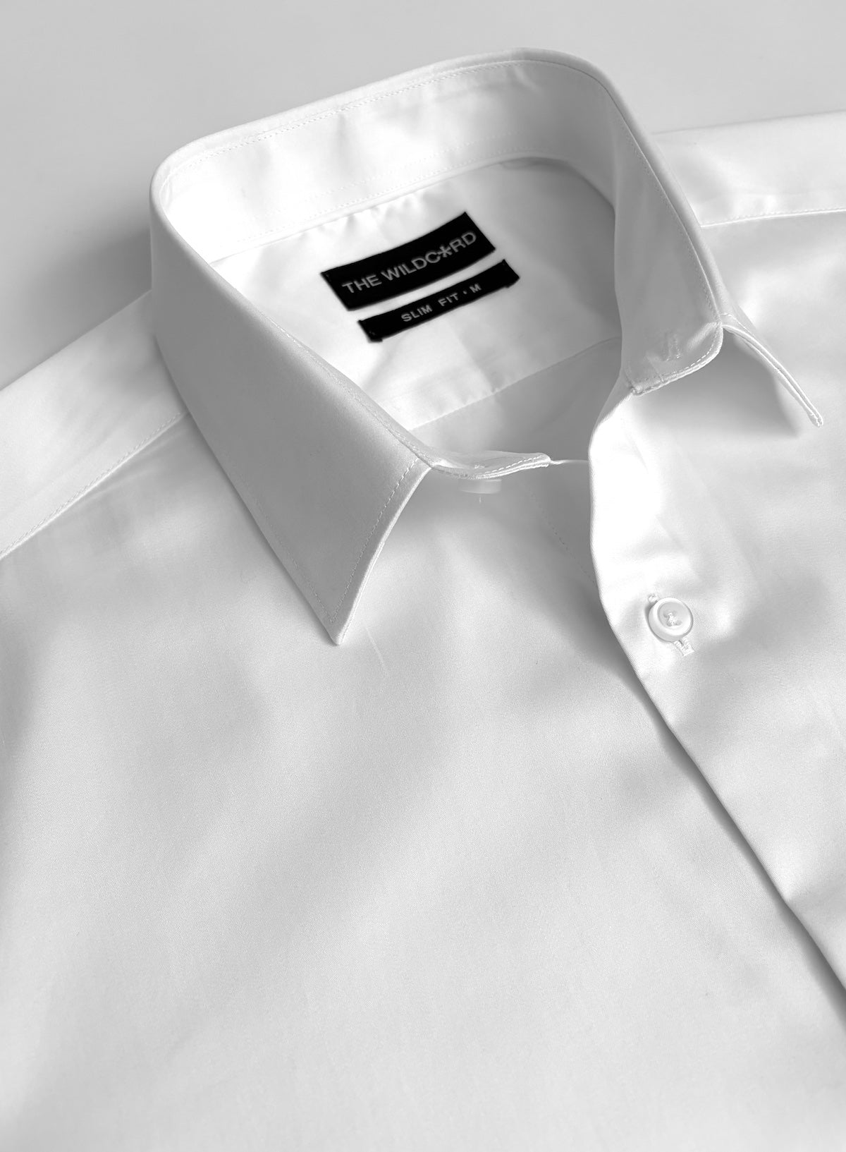 White smart shirt with collar detail on a light background