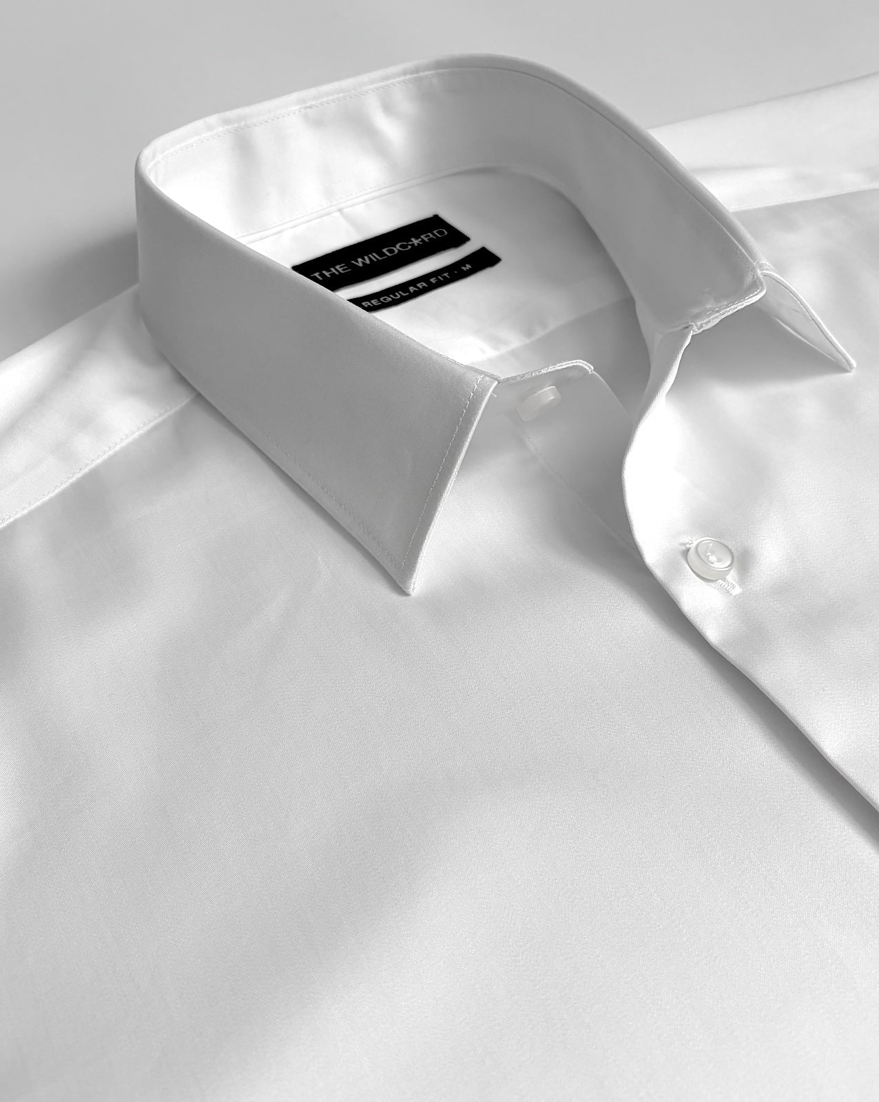 White smart shirt with a label on a light background