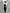 Gray suit jacket with a white shirt and black tie.