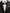 Black tuxedo jacket with a white shirt and black bow tie on a neutral background